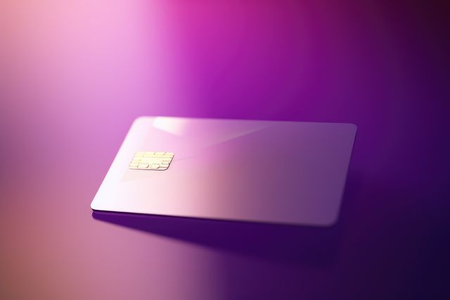 Blank pink credit card with microchip on purple, copy space, created using generative ai technology. Emv chip, banking, spending, technology and finance mock up concept digitally generated image.