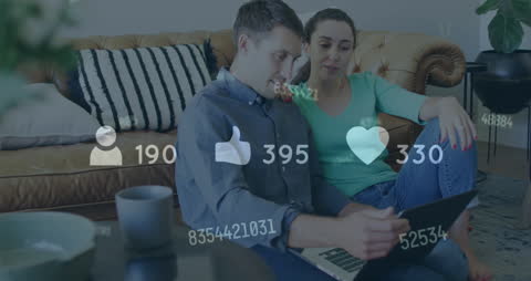 Couple Engaging in Social Media Networking on Laptop at Home
