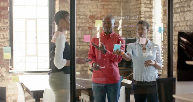 Team brainstorming with sticky notes and glass wall - Download Free Stock Images Pikwizard.com