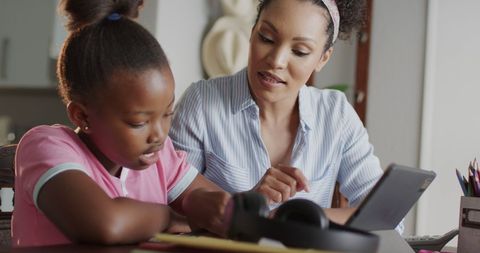 Mother and Daughter Learning Together at Home with Tablet
