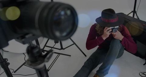 Creative Photgrapher Preparing Shoot with Camera in Studio Environment