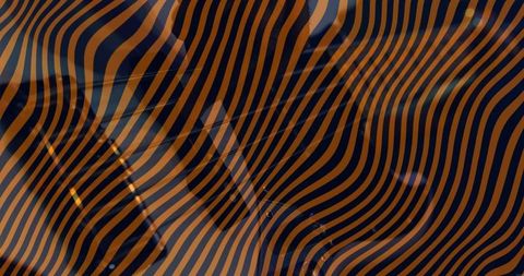Moody man posing in dark blazer with wavy orange and navy stripe overlay