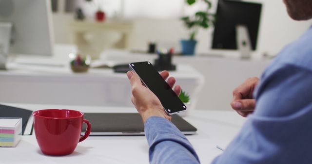 Businessman Using Smartphone in Modern Office with Coffee Mug - Download Free Stock Images Pikwizard.com