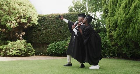 Graduating Students Celebrating with Competitive Enthusiasm Outdoors