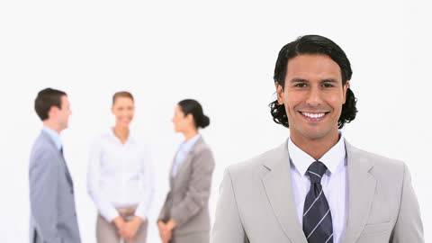 Confident Businessman Posing with Team in Background
