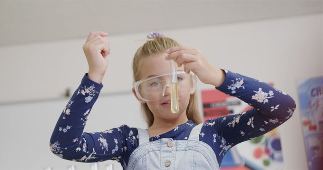 Young girl wearing protective goggles and casual clothing conducting science experiment in school laboratory setting, looking focused and engaged. Great for illustrating educational, STEM, and science-related topics, can be used for children and learning materials, as well as educational article illustrations.
