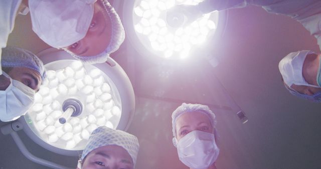 Surgeons Performing Operation Under Bright Lights in Operating Room - Download Free Stock Images Pikwizard.com