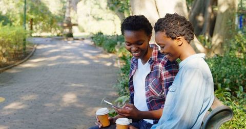 Happy Twin Sisters Using Smartphone Outdoors With Coffee - Download Free Stock Images Pikwizard.com