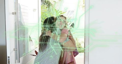 Reunion hug at smart home doorway with green holographic interface overlay
