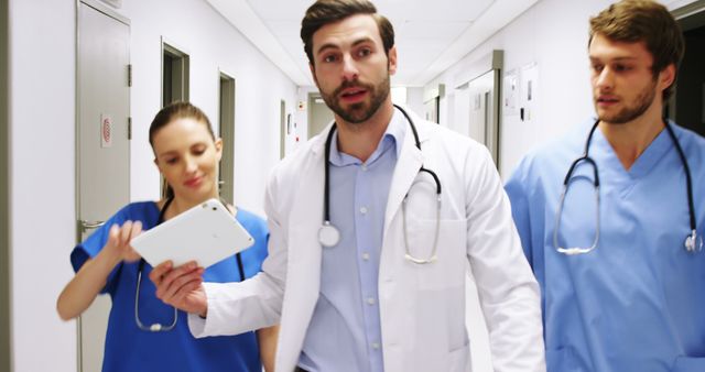 Healthcare Team Walking in Hospital Corridor with Digital Tablet - Download Free Stock Images Pikwizard.com