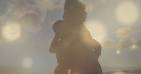 Couple Embracing on Beach with Glowing Light Effects