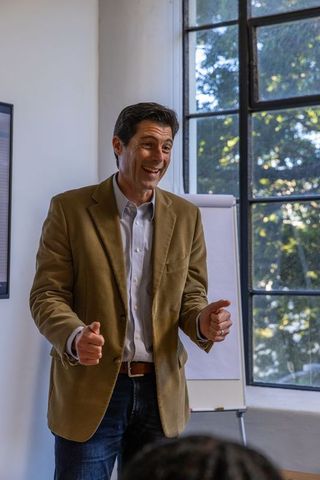 Confident Businessman Presenting at Office Meeting