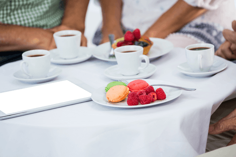 Expertly arranged transparent macarons and coffee meeting