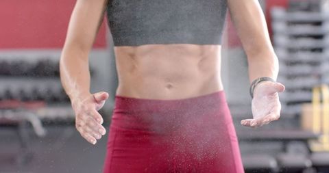 Fit Woman in Gym Chalk Powder Preparation for Workout