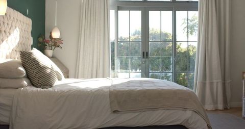 Luxurious Minimalist Bedroom with Green Accent Wall and Natural Light