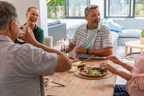 Senior Friends Enjoying Lunch Together in Bright Dining Room