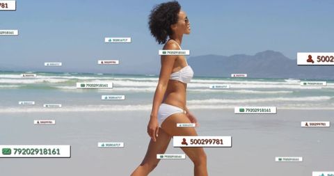 Woman Walking on Beach with Floating Digital Data Elements
