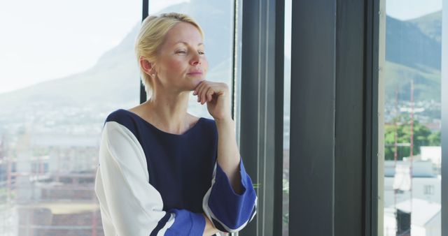 Professional Woman Reflecting by Office Window - Download Free Stock Images Pikwizard.com