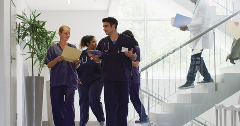 Diverse Doctors Communicating in Hospital Corridor - Download Free Stock Images Pikwizard.com