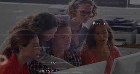 Team Collaborating Around Computer Desk in Modern Office