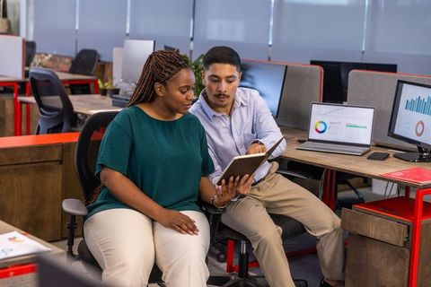 Diverse professionals analyzing data in open-plan office