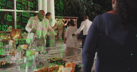 Evening garden reception mingling around outdoor dining table with green binary overlay