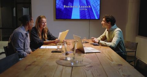 Group of professionals collaborating in evening business meeting