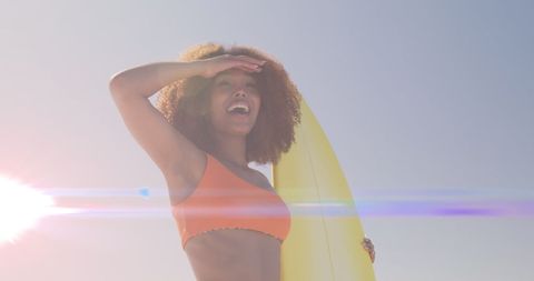 Happy Woman Holding Surfboard Under Sunlight - Download Free Stock Images Pikwizard.com