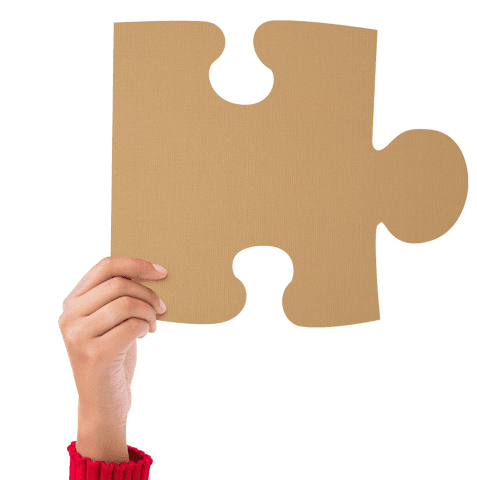 Hand holding large puzzle piece on transparent background