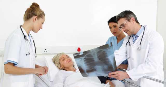 Doctors Examining Chest X-Ray with Patient in Hospital Bed - Download Free Stock Images Pikwizard.com