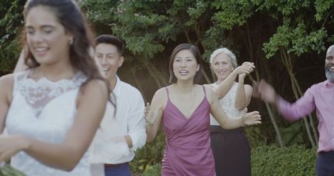 Joyous wedding celebration with clapping guests outdoors