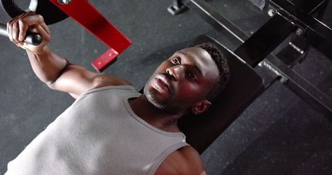 Focused Athlete Lifting Weights at Gym