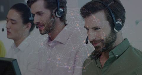 Team of Customer Support Representatives with Headsets Collaborating