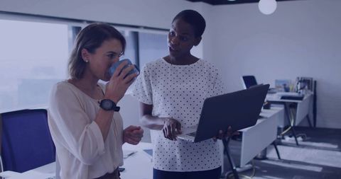 Colleagues Collaborating in Modern Office with Technology and Focus