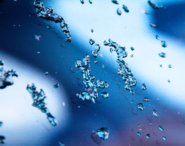This captures the delicate beauty of frozen water drops on a glass surface during winter. Ideal for backgrounds, seasonally themed designs, and conveying themes of cold, frost, and winter weather. Suitable for use in weather-related media, nature projects, and winter holiday promotions.