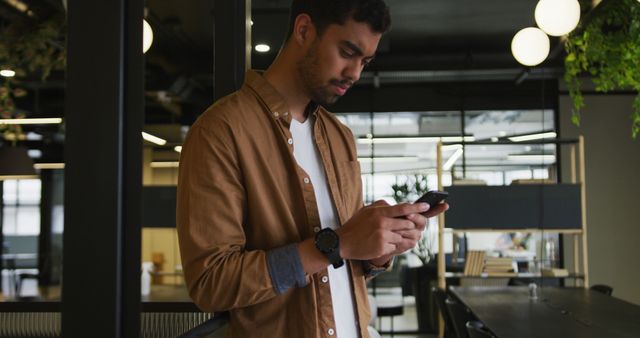 Young Professional Concentrating on Smartphone in Modern Office - Download Free Stock Images Pikwizard.com