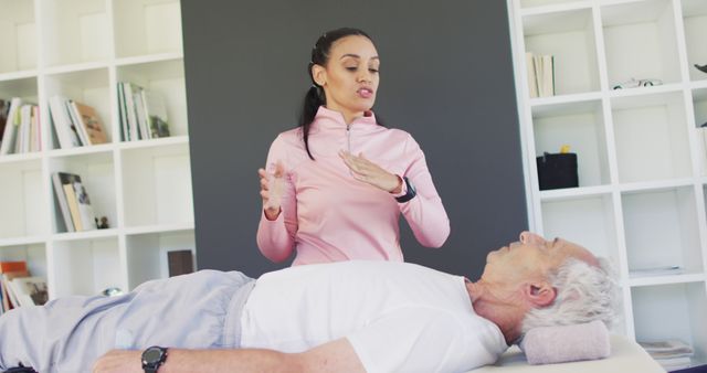 Physical Therapist Assisting Senior Man with Exercises on White Couch - Download Free Stock Images Pikwizard.com