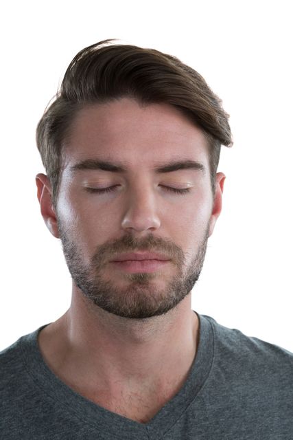 Man standing with eyes closed, appearing calm and relaxed. Ideal for use in content related to meditation, mindfulness, mental health, stress relief, and wellness. Can be used in articles, blogs, advertisements, and social media posts promoting relaxation and inner peace.
