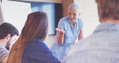 Engaged senior instructor leading workshop in conference room