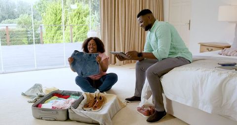 Couple Packing for Adventure Planning Exciting Getaway Together