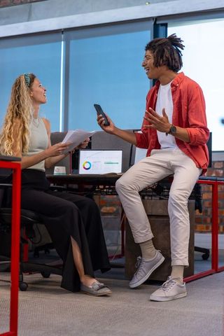 Diverse Coworkers Collaborating on Data Analytics in Modern Office