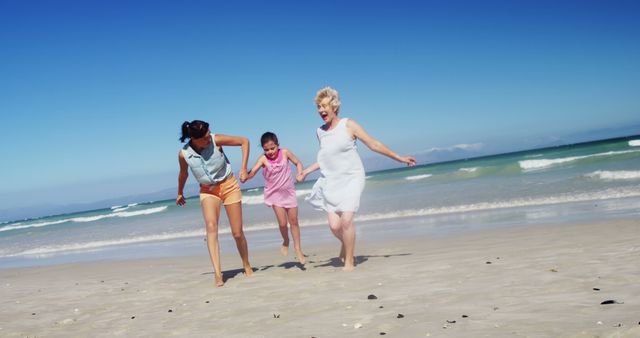 A diverse group of females, including an African American, a young girl, and a Caucasian senior, are enjoying a playful run on a sunny beach, with copy space. Their joyful expressions and active engagement with the seaside environment evoke a sense of freedom and happiness.