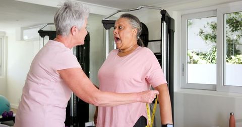 Senior Couple Exercising Together at Home Gym
