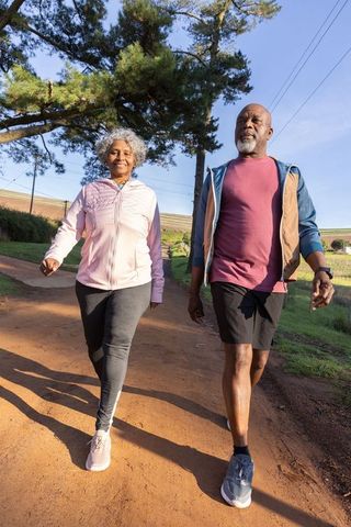 Senior Couple Enjoys Healthy Walk on Scenic Rural Trail