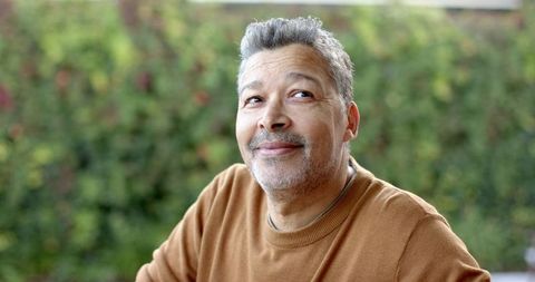 Mature man in contemplation amidst lush garden