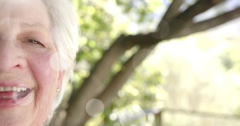 Senior Woman Enjoying Bright Day in Garden