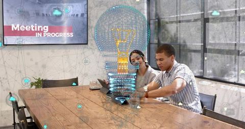 Collaborative ar brainstorming with holographic lightbulb and tablet in modern boardroom