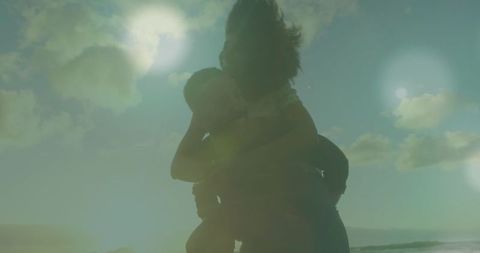 Joyful Couple Enjoying Beach with Digital Light Effects