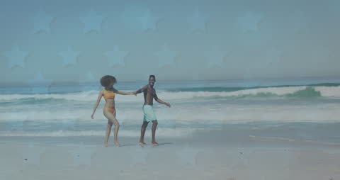 Joyful Couple Walking on Sunny Beach with Overlayed Stars