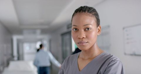 Confident African American Nurse in Modern Hospital Corridor